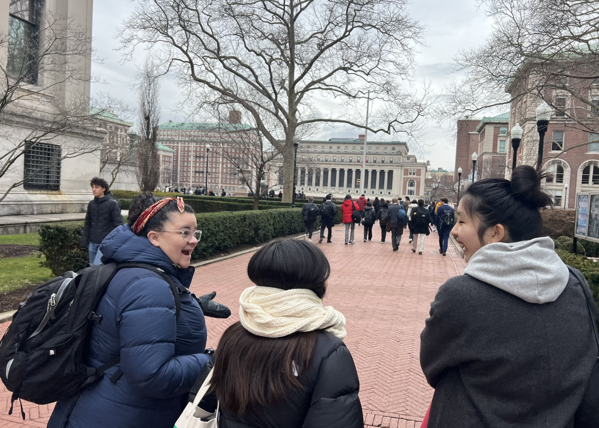 Model UN members Ella Cho '25 and Esther Lee '27 converse with social studies teacher Mackenzie Mcilmail while walking towards the upcoming conference.